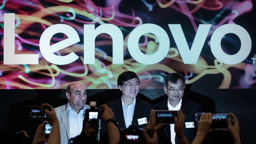 Lenovo's CEO Yang Yuanqing (C) and President Gianfranco Lanci (L) pose before a press conference in Hong Kong