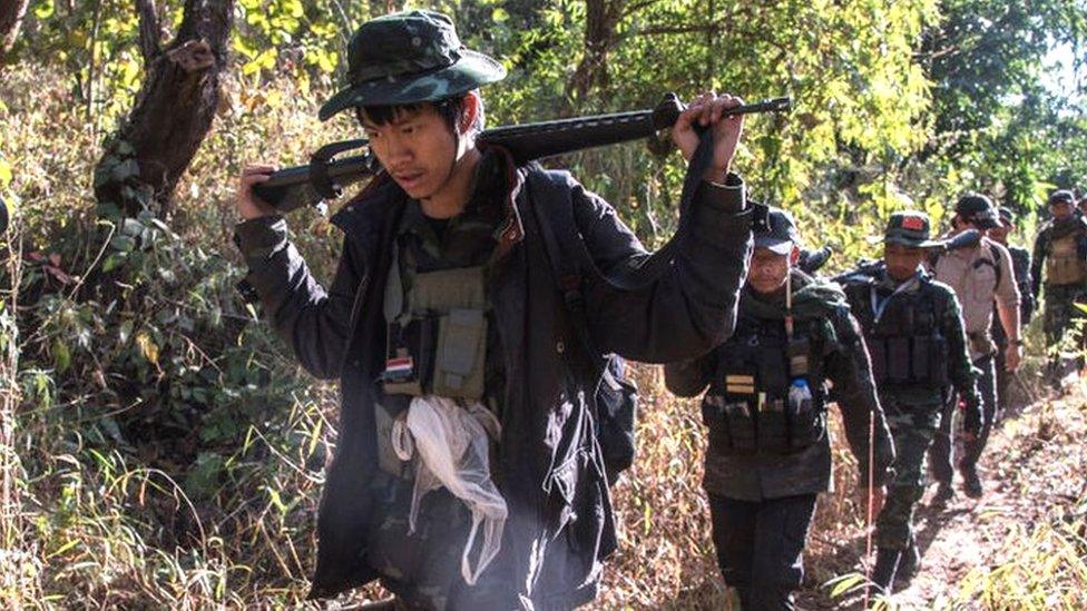 KNDF soldiers walking in a forest on their way to a military operation earlier in 2021