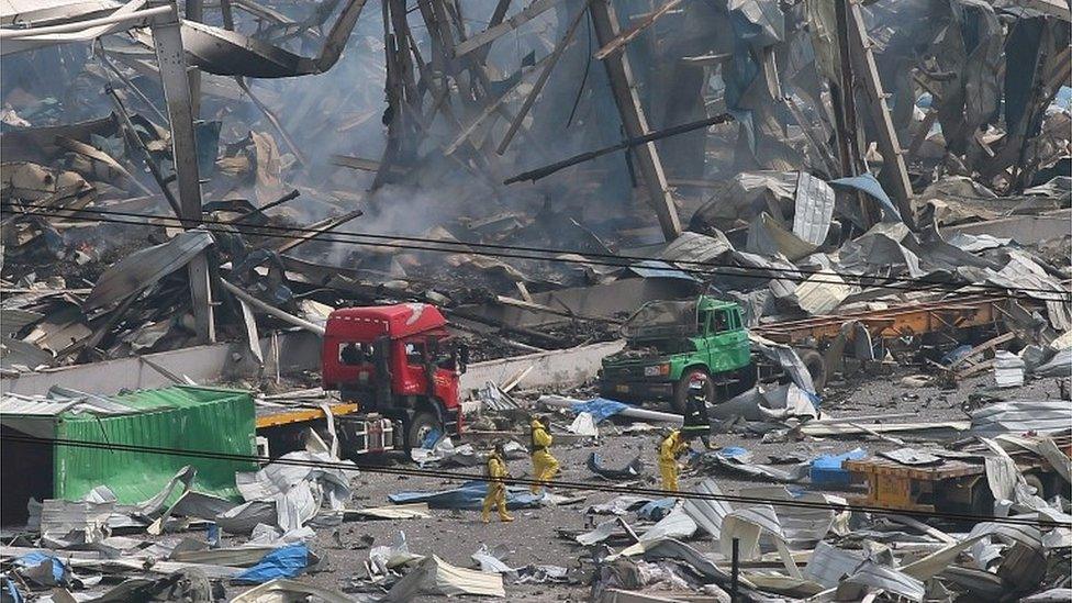 escuers search amongst the debris after a huge explosion rocked Tianjin, China, 14 August 2015.