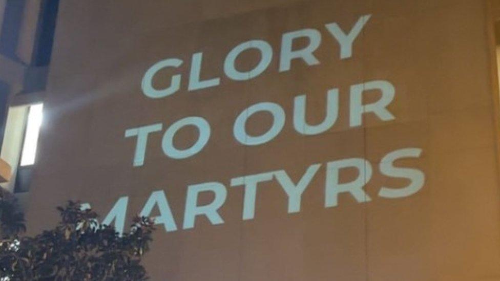 Slogans beamed on to side of library at GW University on 24 October 2023