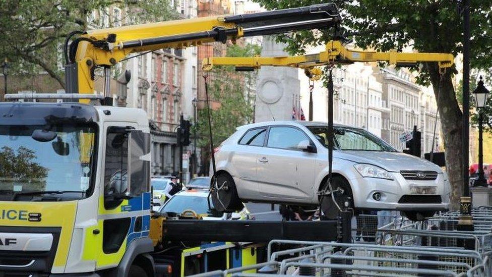 A car being lifted away from Whitehall