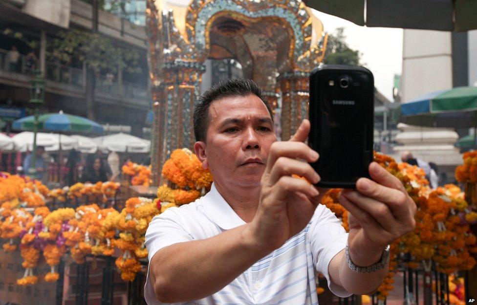 Man takes a selfie at Erawan shrine