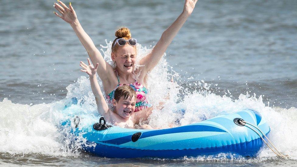 People on dinghy on Scarborough beach