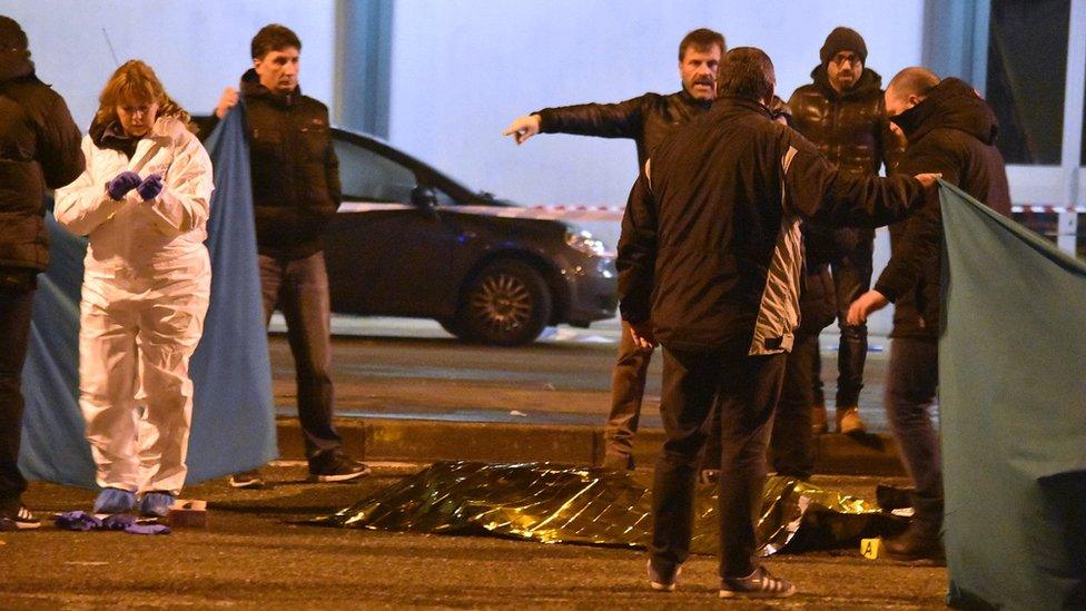 Italian police cordon off an area after a shootout between police and a man in Milan"s Sesto San Giovanni neighbourhood, early Friday, Dec. 23, 2016.