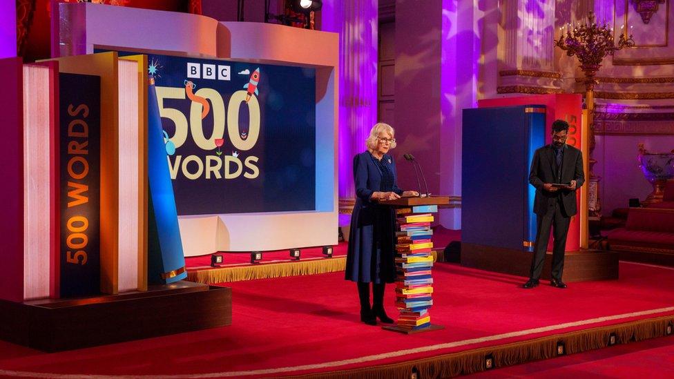 Queen Camilla at a podium for the ˿'s 500 Words competition