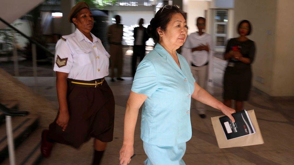 Yang Fenglan leaves court, Dar Es Salaam, 2016