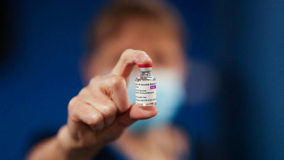 Vaccines in Scotland - a healthcare worker holds a vial of vaccine