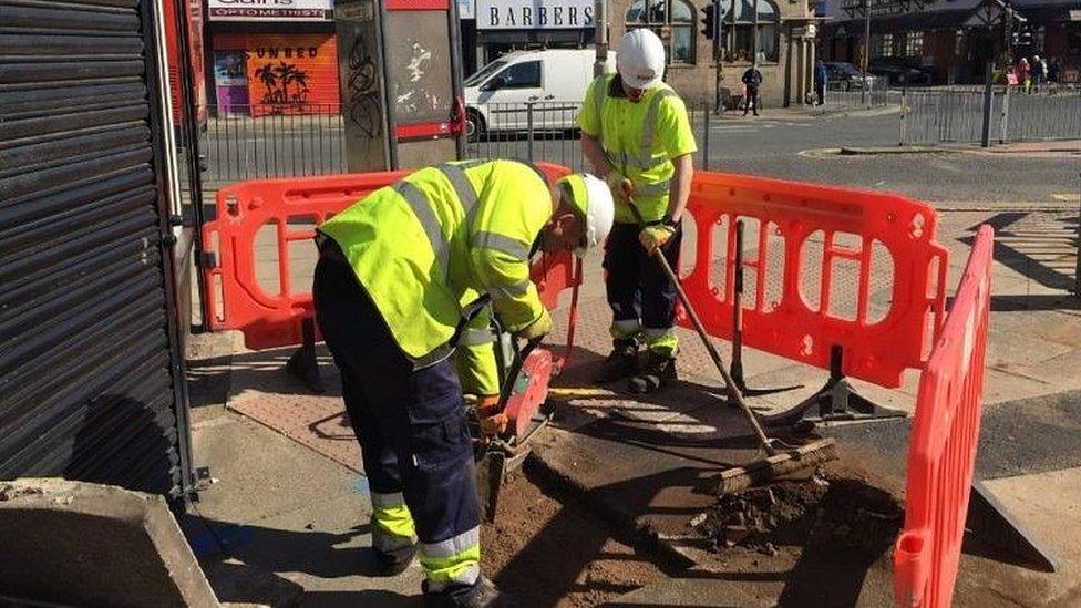 Builders doing work on road