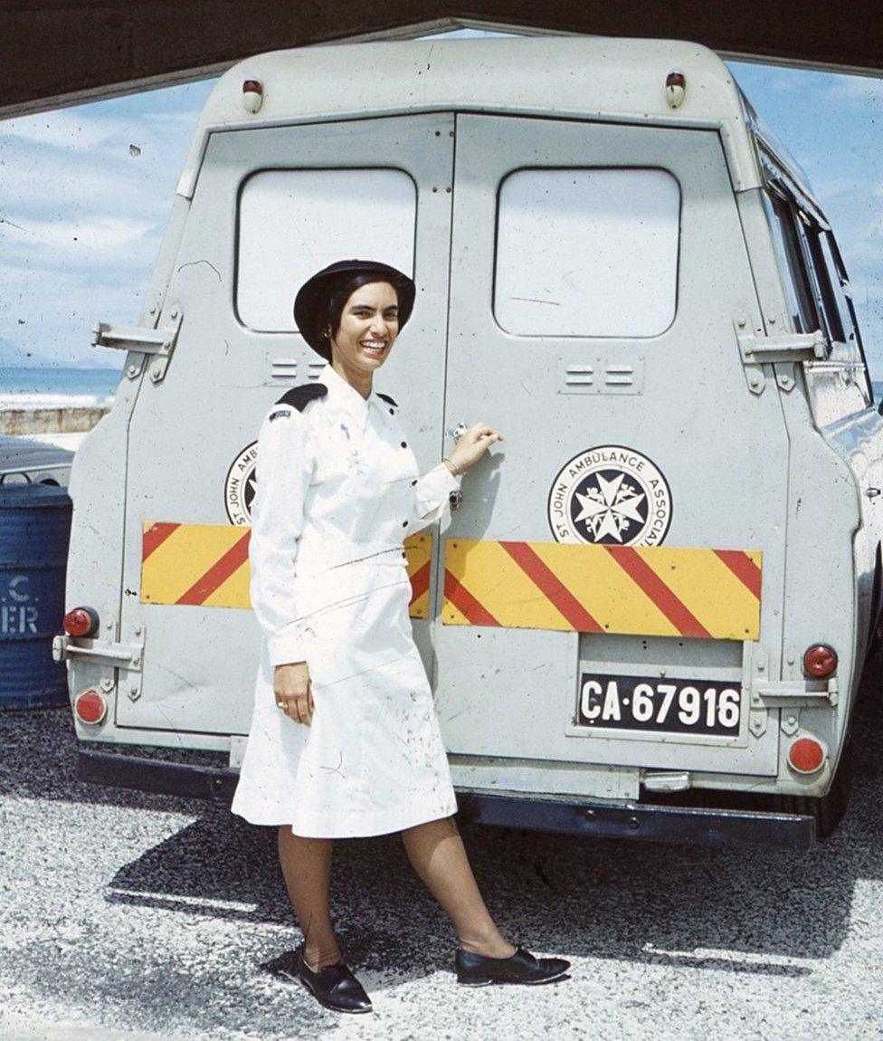 Margaret in her nurse's uniform in front of a St John's ambulance