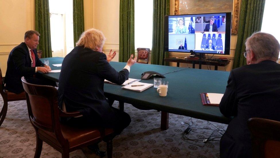 Prime Minister Boris Johnson (C) at a Cabinet Room meeting with Europe Adviser and Chief Negotiator of Task Force Europe David Frost (L) and Minister for the Cabinet Office Michael Gove (R)