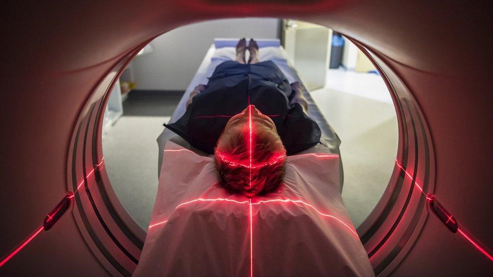 Patient going through a brain medical scanner in a hospital