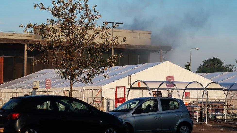 Smoke seen billowing from the roof of the supermarket