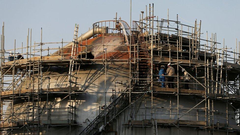 File photo showing workers inspecting damage at the Abqaiq oil facility in Saudi Arabia (20 September 2019)