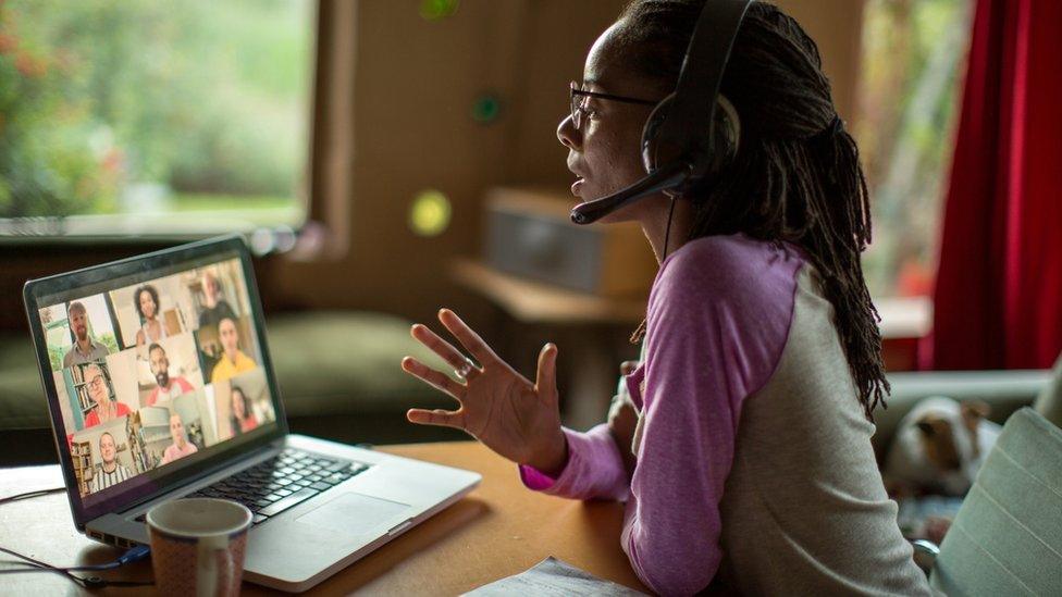 woman on headset in Zoom meeting