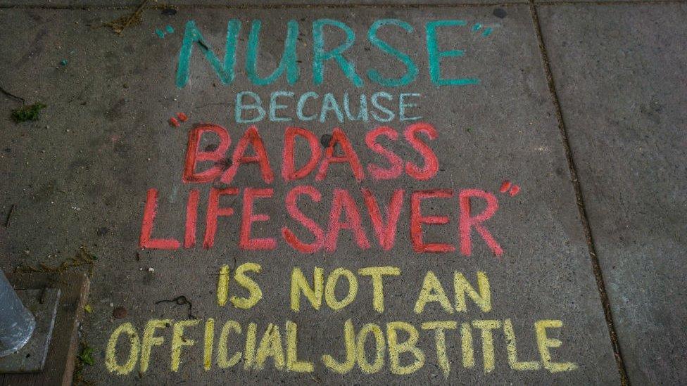 A note saying 'Nurse: Because Badass Lifesaver is not a Job Title' is left in chalk outside New York's Mount Sinai