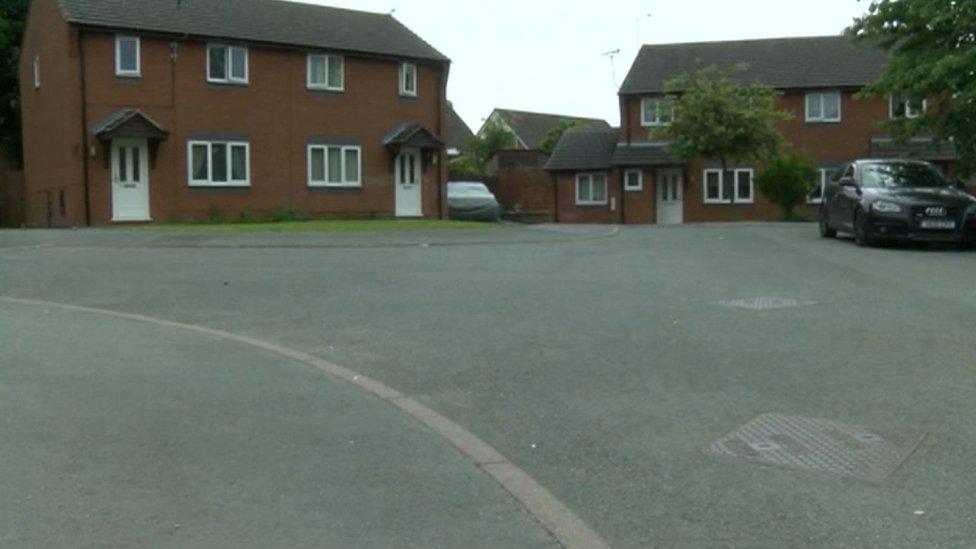 A picture of a housing estate showing red bricked semi detached houses