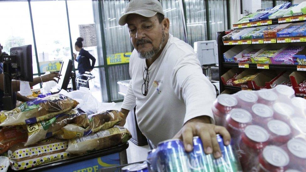 A man picking items in a supermarket in Nassau, Bahamas,