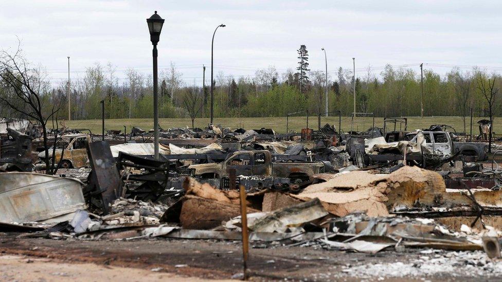 At least ten gutted and charred vehicles