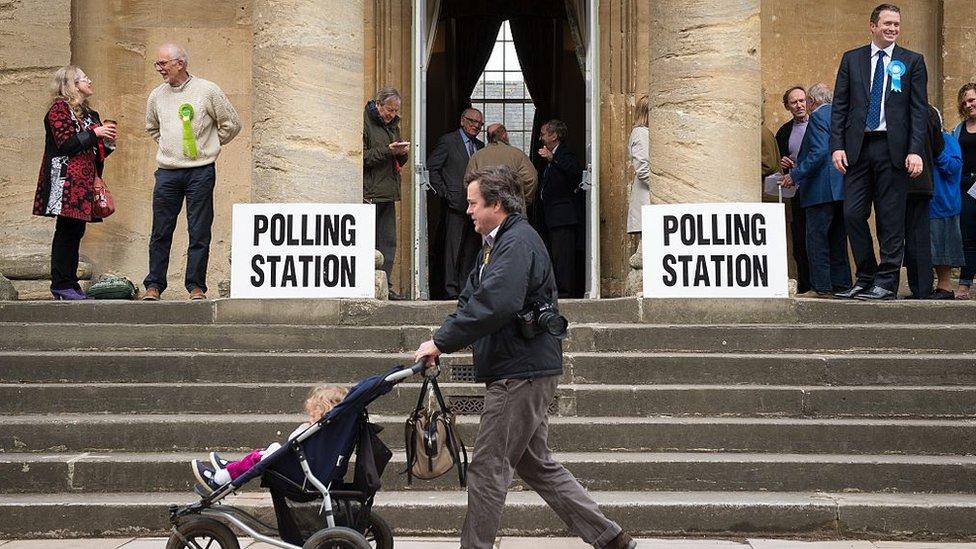 Members of the public arrive to cast their votes at a polling station in Chipping Norton town hall