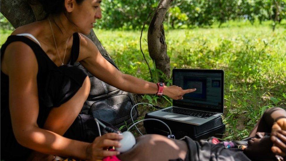 Researcher monitoring a pregnant woman