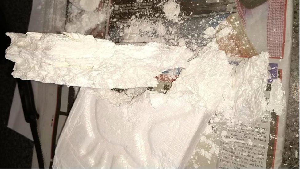 Image showing a large crumbled block of cocaine on a newspaper