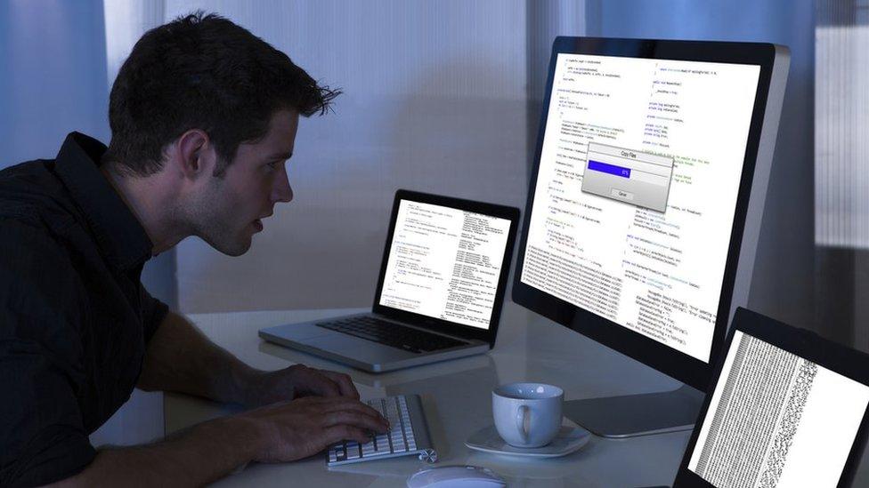 Man working with computer and laptop