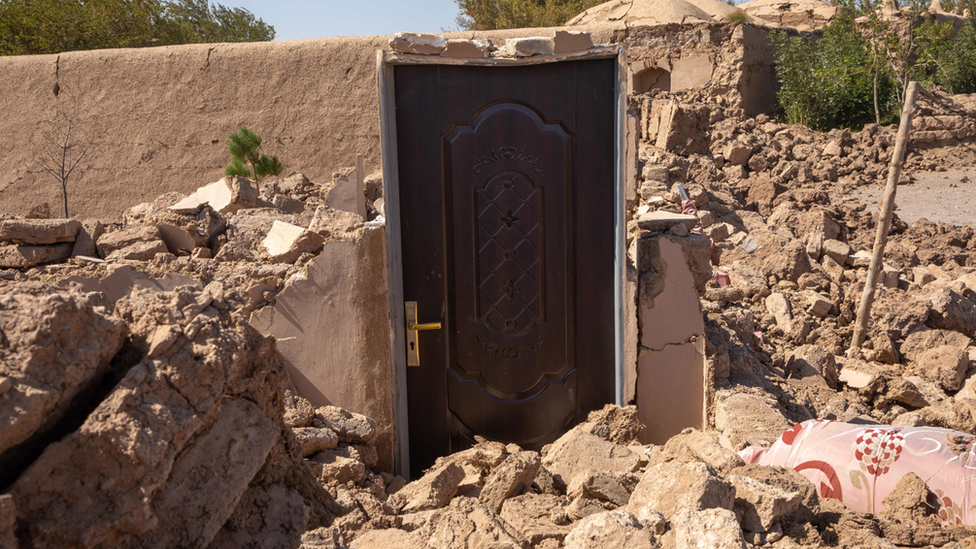 A door is all that remains of a building in Herat after the massive earthquake, leaving the city and the houses in ruins.