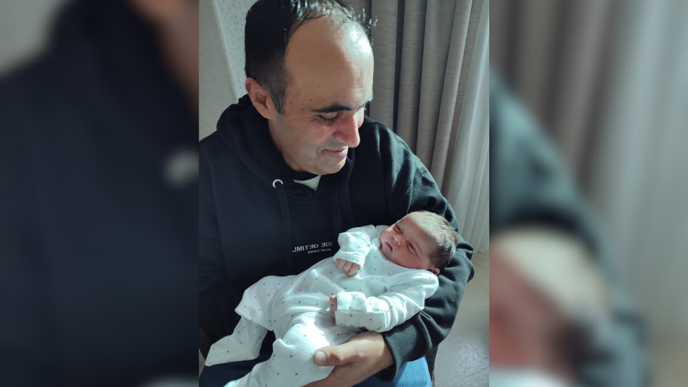 Raj Gill holding baby Karan