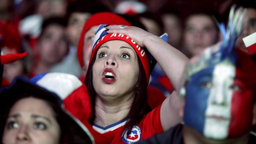 Fans of Chile react while watching a broadcast of the Copa America semi-final soccer match between Chile and Peru at the Fan Fest in Santiago, Chile June 29, 2015.