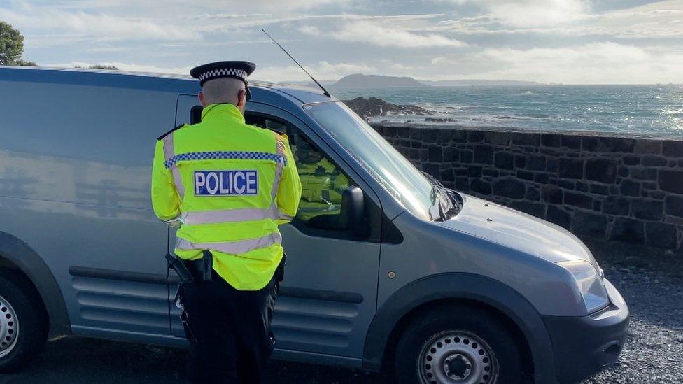 Police officer speaking to a driver