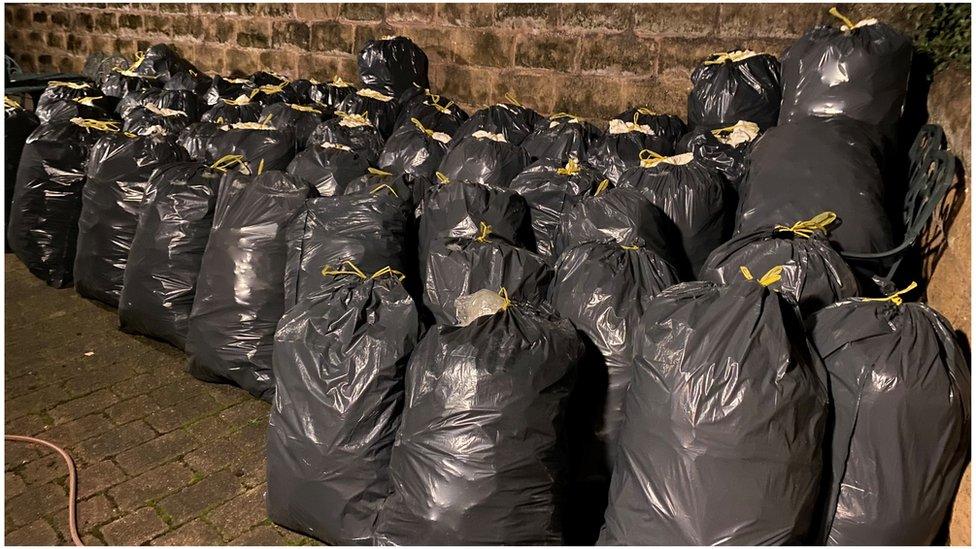 Dozens and dozens and bin bags packed full of spray foam, neatly stacked in Sandra's back garden awaiting removal