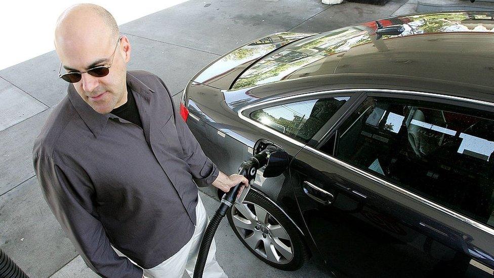 Man filling up car at petrol station