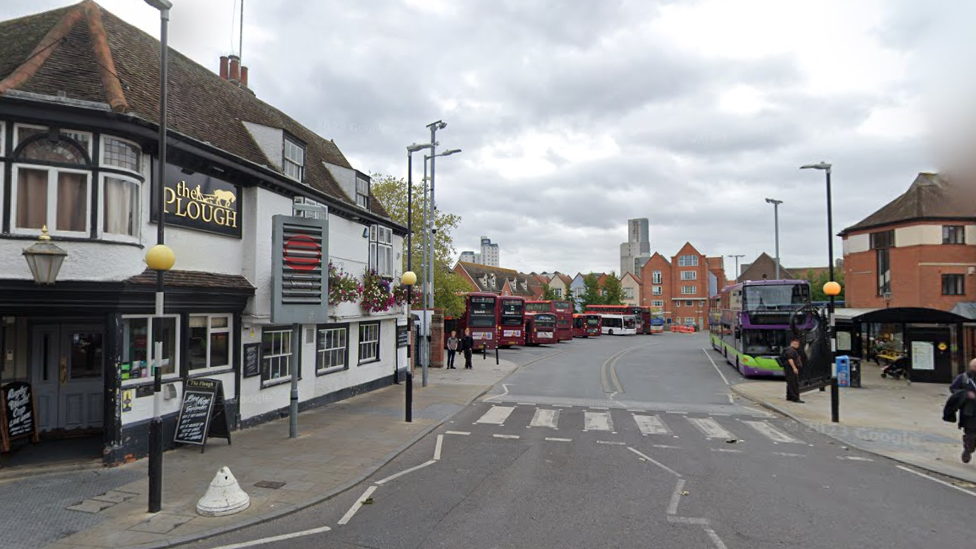 A generic street view showing the Plough pub on the corner and the entrance to Old Cattlemarket bus station.