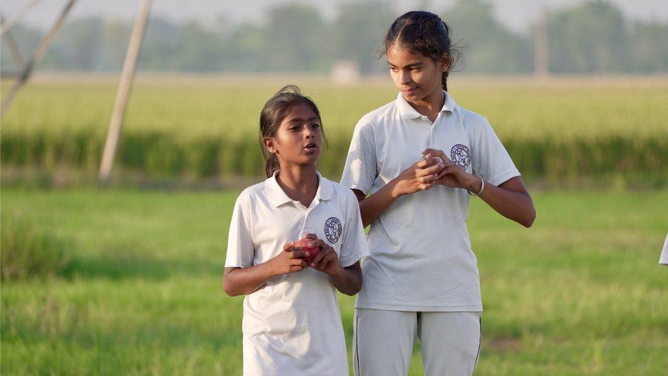 Simran practicing bowling at the field