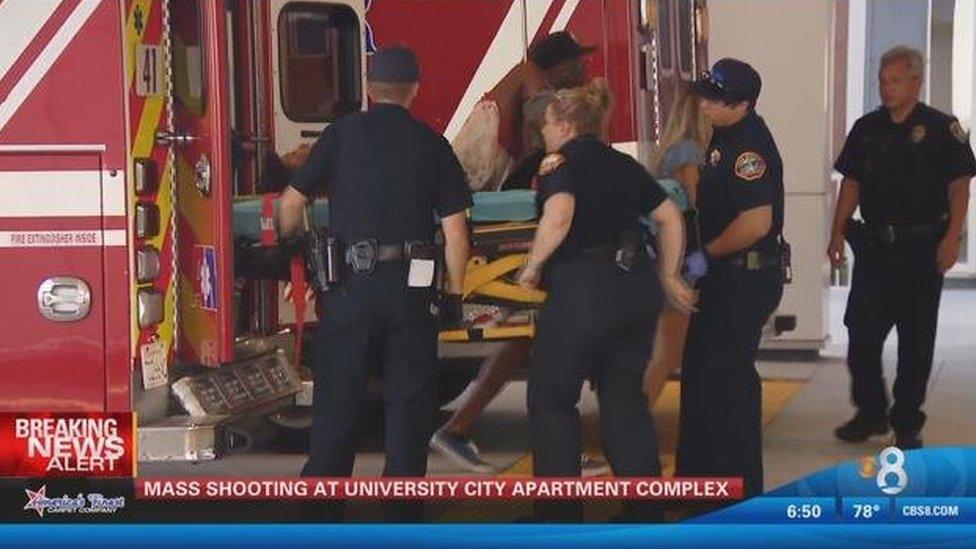 police loading injured person onto ambulance