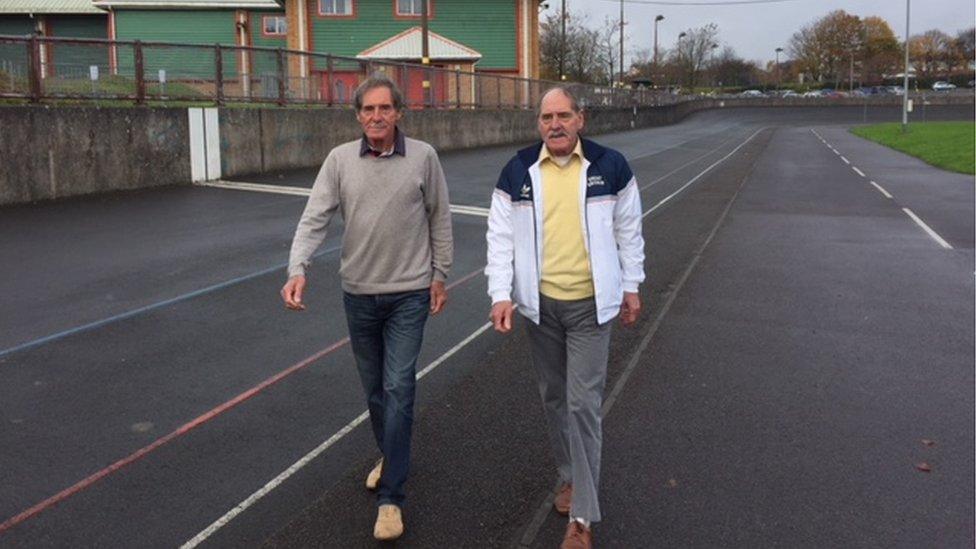 Lynn Hughes, in a white GB track jacket and his twin brother Eric