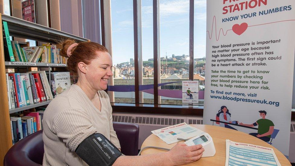 A person having their blood pressure taken