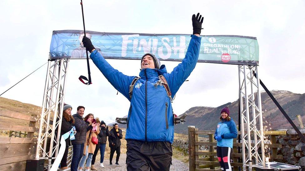 Greg James crossing finish line