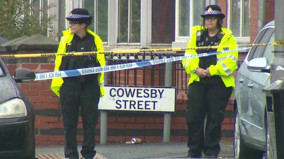 Officers standing by a sign for Cowesby Street