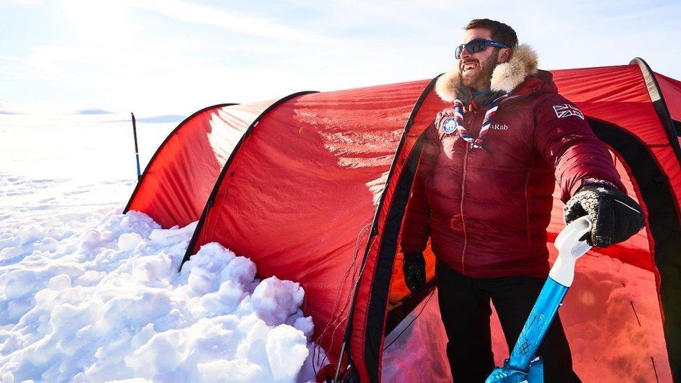 Joe Doherty standing outside his tent during one of his training expeditions