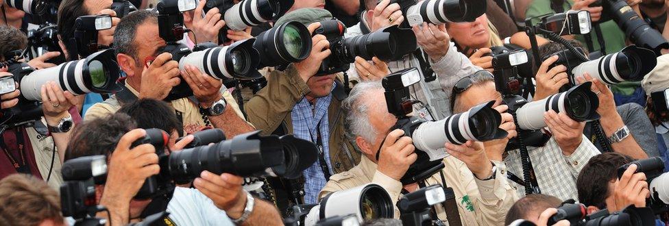 A large group of press photographers