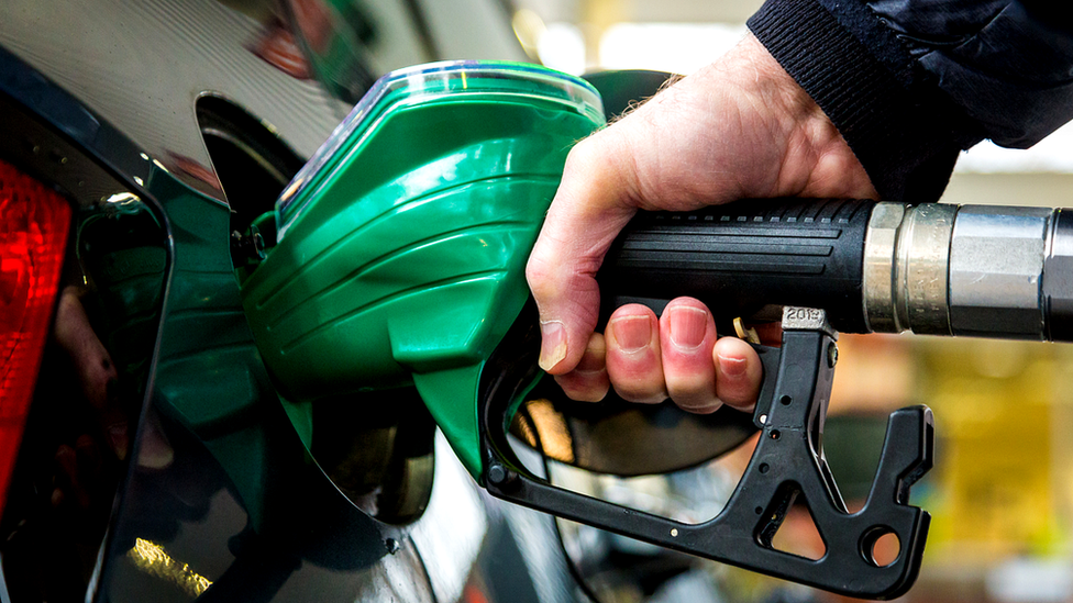 Man filling car with fuel