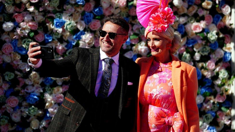 Man and woman take a selfie at Aintree