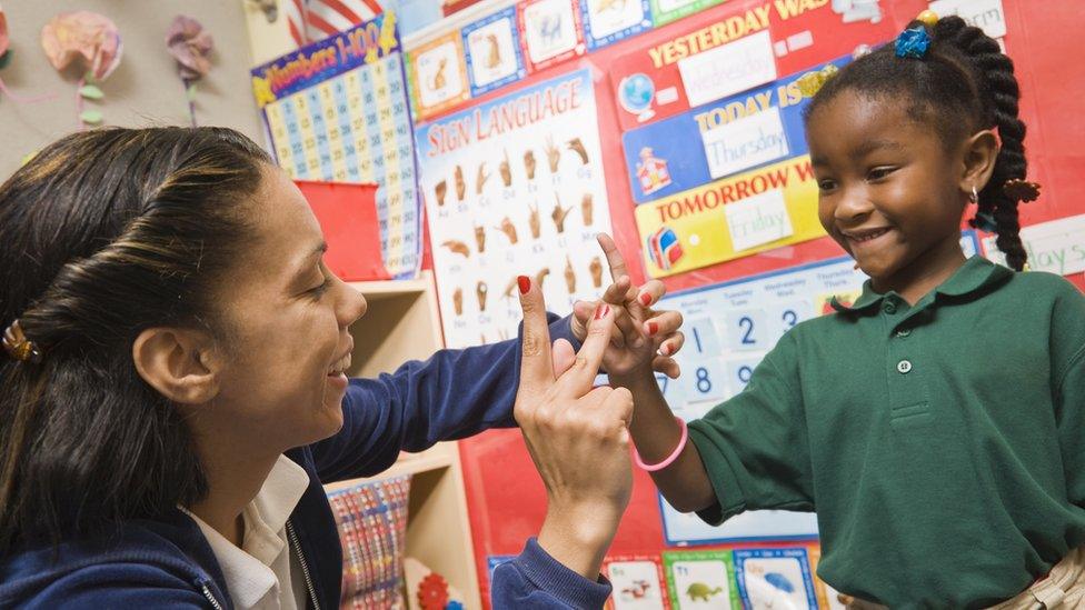 teacher-showing-child-sign-language.