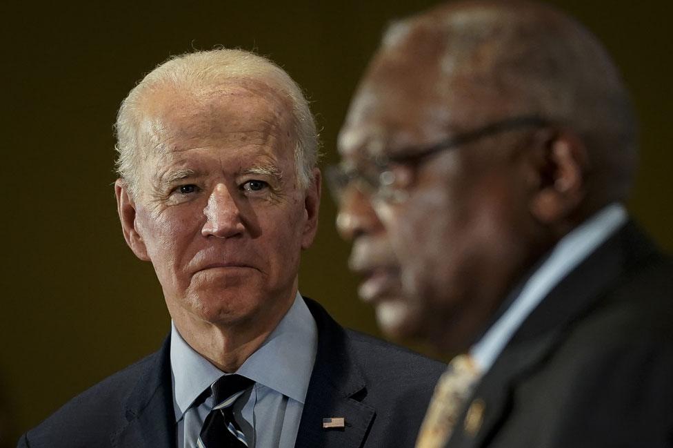 Joe Biden listens to James Clyburn