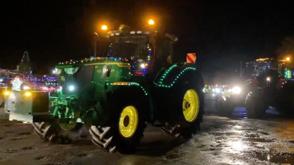 A tractor decorated with Christmas lights