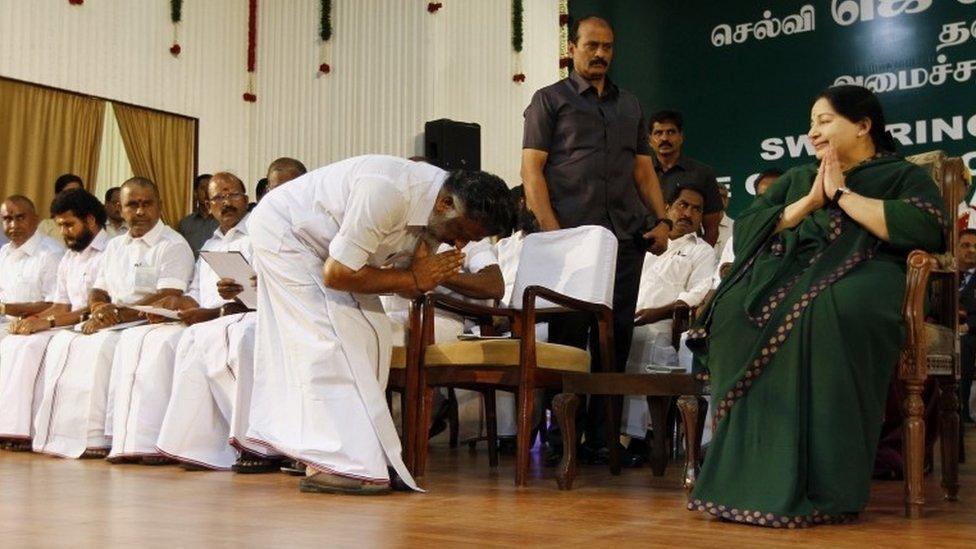 Former chief minister O. Panneerselvam bows in front of AIADMK leader Jayaram Jayalalitha after she took oath as the new Chief Minister of Tamil Nadu