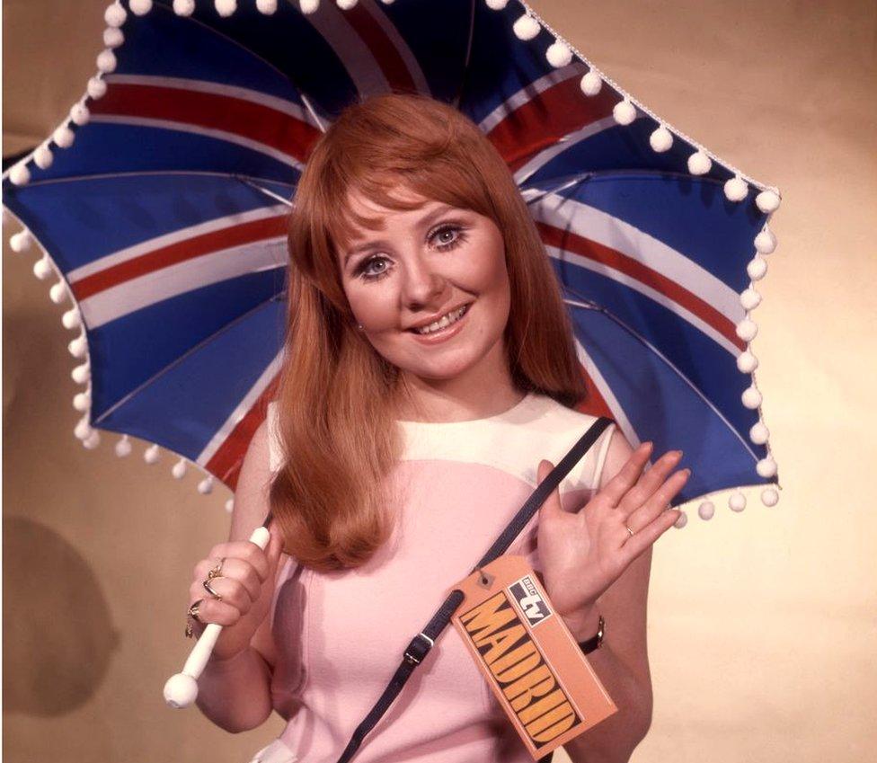 Lulu holding a union jack umbrella