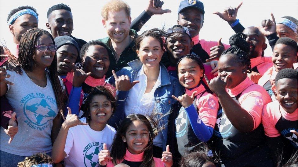 Prince Harry and Meghan pose with surf mentors as they visit Waves for Change