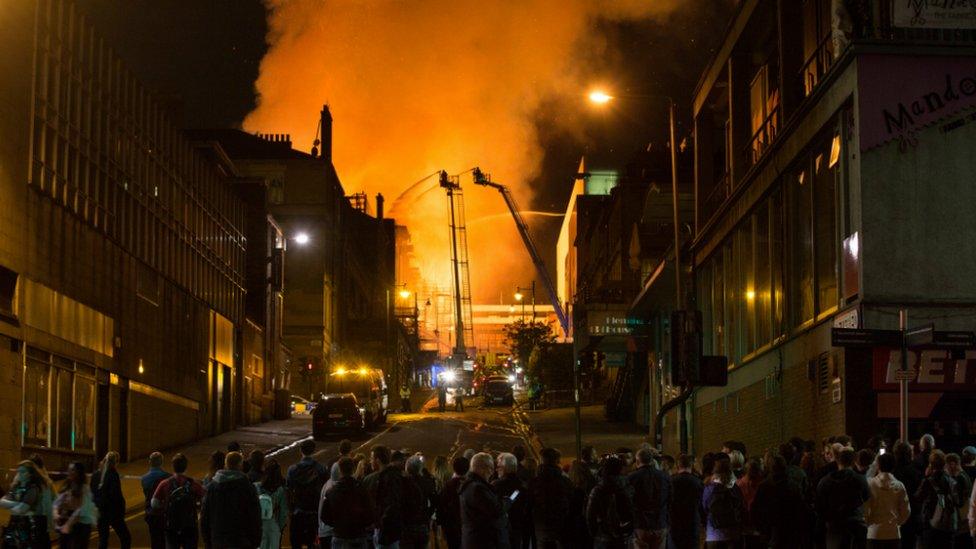 Crowds look on as firefighters tackle the blaze